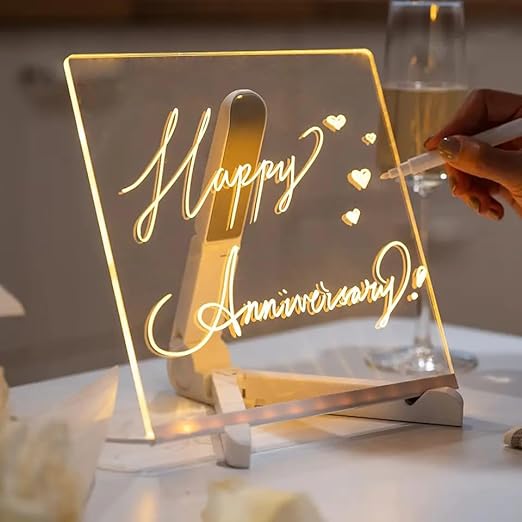 Acrylic LED writing board displaying 'Happy Anniversary' with a hand holding a marker