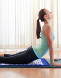 Woman practicing yoga on an acupressure mat and cushion set for relaxation and pain relief