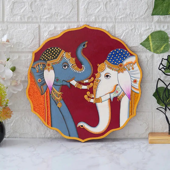 Colorful framed canvas wall art featuring two elephants adorned with decorative accessories