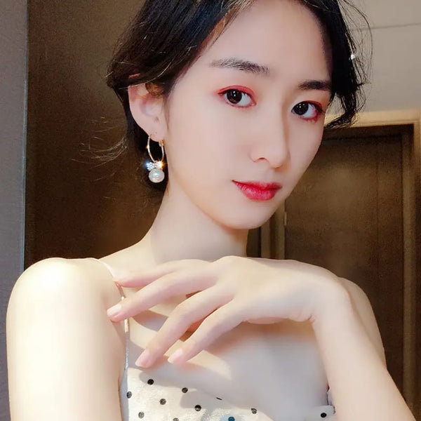 Model wearing elegant bow knot earrings featuring a chic design with a pearl detail