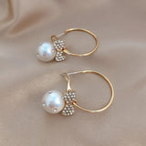 Elegant bow knot earrings featuring a pearl and sparkly embellishments for a chic look