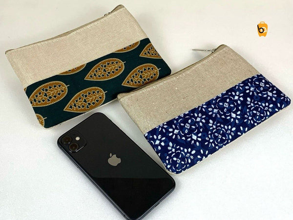 Ethnic cotton canvas clutch bags in blue and green patterns with a phone for scale