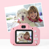 Kids mini HD camera in pink capturing a smiling child with a dog, showcasing fun moments