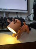 Cute mini LED desk lamp designed as a playful dog figure with adjustable limbs