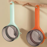 Colorful peelers with storage hanging on a wall, designed for efficient food preparation