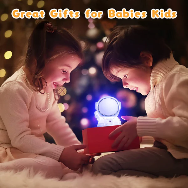 Kawaii silicone astronaut night light being unwrapped by children for a cozy bedtime experience