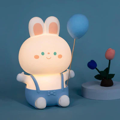 Cute silicone bunny night light with blue overalls and a balloon, perfect for children's rooms