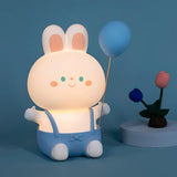 Cute silicone bunny night light with blue overalls and a balloon, perfect for children's rooms