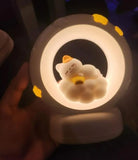 Sleeping Cat LED Night Light in a circular design with a cute cat figure resting on a cloud