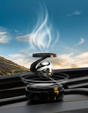 Solar levitating car air freshener with a sleek design and floating aroma emblem in a scenic backdrop