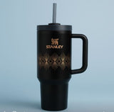 40oz stainless steel tumbler with handle in black featuring gold geometric design and a straw