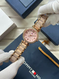 Tommy Hilfiger stylish women's watch with pink face and gold-tone bracelet for a chic look