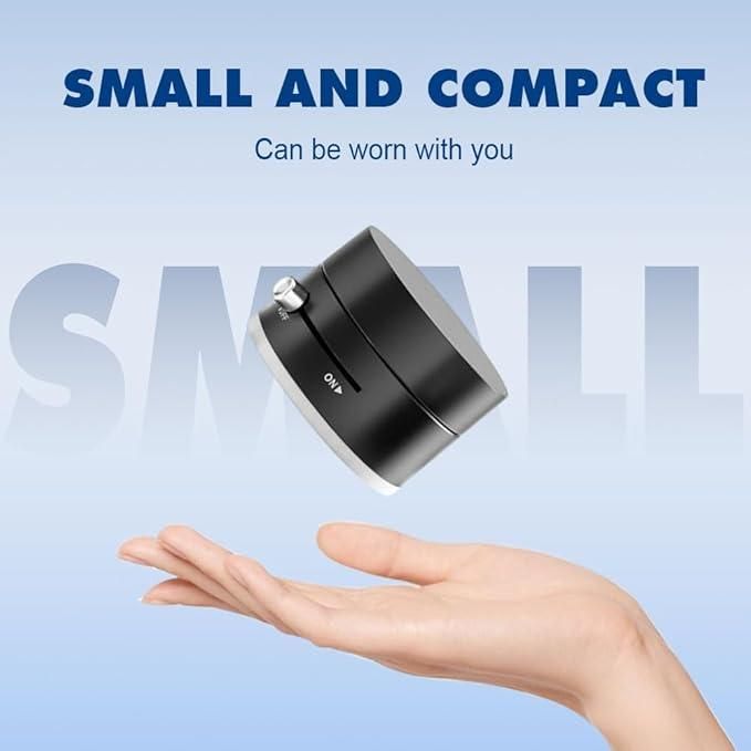 Small and compact black device held above hand with on off switch visible