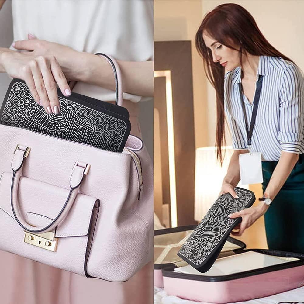 Woman placing EMS foot massager pad with geometric pattern into a pink handbag and holding it near a suitcase